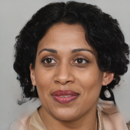 Joyful black adult female with medium  brown hair and brown eyes