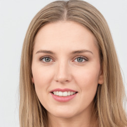 Joyful white young-adult female with long  brown hair and green eyes