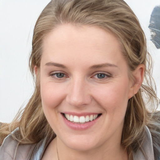 Joyful white young-adult female with medium  brown hair and blue eyes