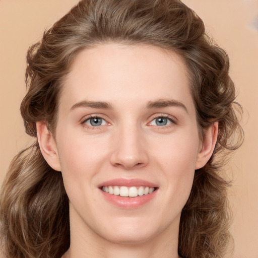 Joyful white young-adult female with long  brown hair and green eyes