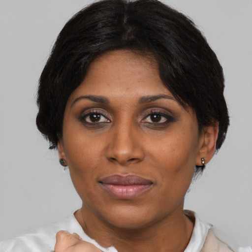 Joyful asian adult female with medium  brown hair and brown eyes