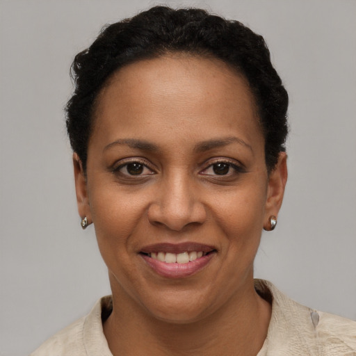 Joyful black young-adult female with short  brown hair and brown eyes