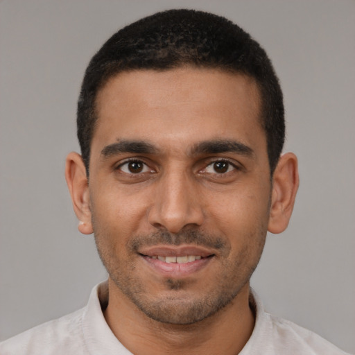 Joyful latino young-adult male with short  black hair and brown eyes