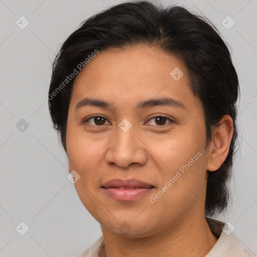 Joyful latino adult female with medium  brown hair and brown eyes