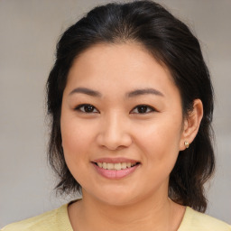 Joyful asian young-adult female with medium  brown hair and brown eyes