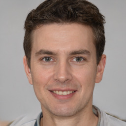 Joyful white adult male with short  brown hair and brown eyes