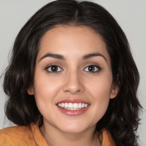 Joyful white young-adult female with medium  brown hair and brown eyes