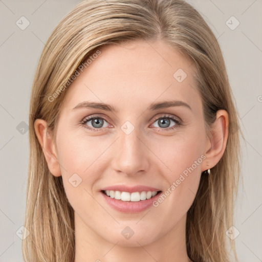 Joyful white young-adult female with long  brown hair and blue eyes