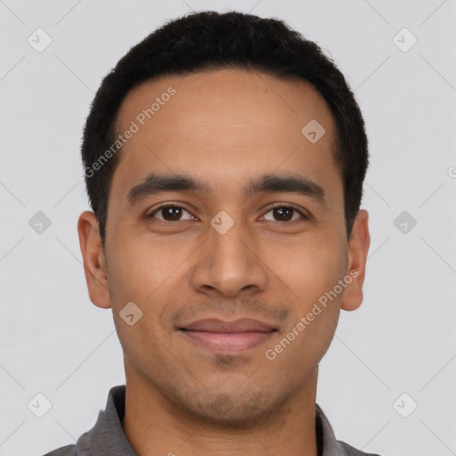 Joyful latino young-adult male with short  black hair and brown eyes