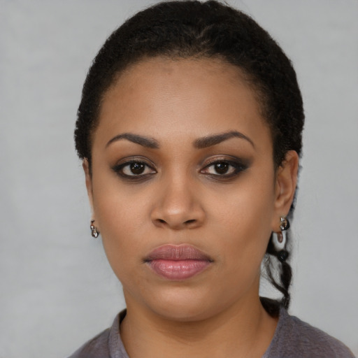 Joyful latino young-adult female with short  black hair and brown eyes