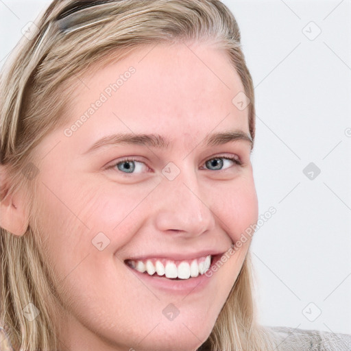 Joyful white young-adult female with long  brown hair and blue eyes