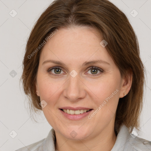 Joyful white adult female with medium  brown hair and grey eyes