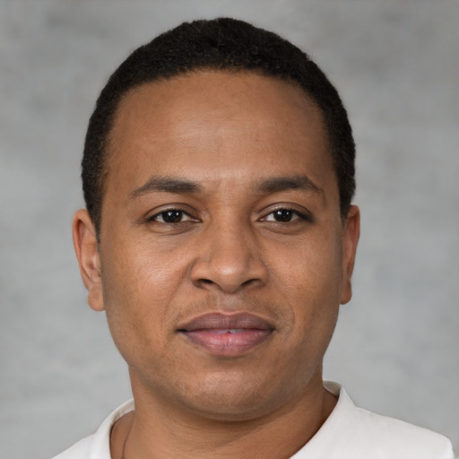 Joyful latino adult male with short  brown hair and brown eyes