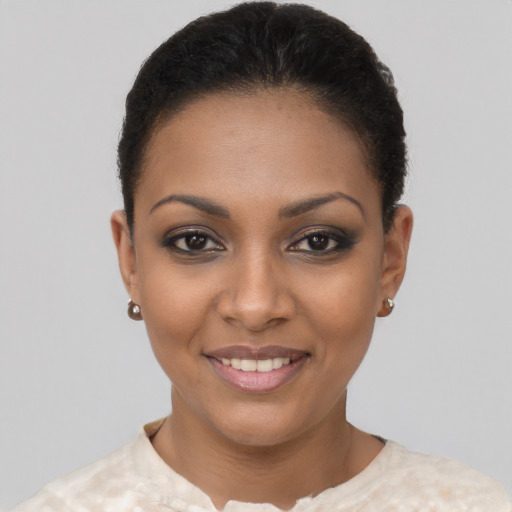 Joyful black young-adult female with short  brown hair and brown eyes