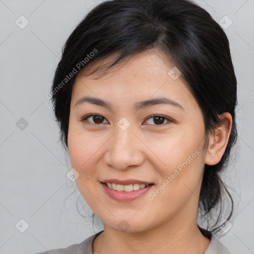 Joyful asian young-adult female with medium  brown hair and brown eyes