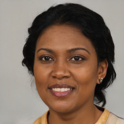 Joyful latino adult female with medium  black hair and brown eyes