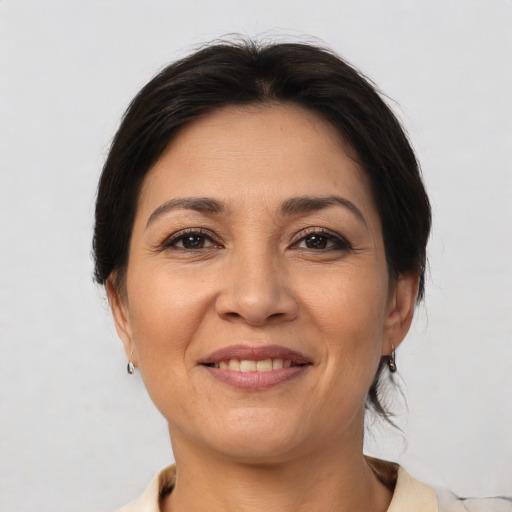 Joyful latino young-adult female with medium  brown hair and brown eyes