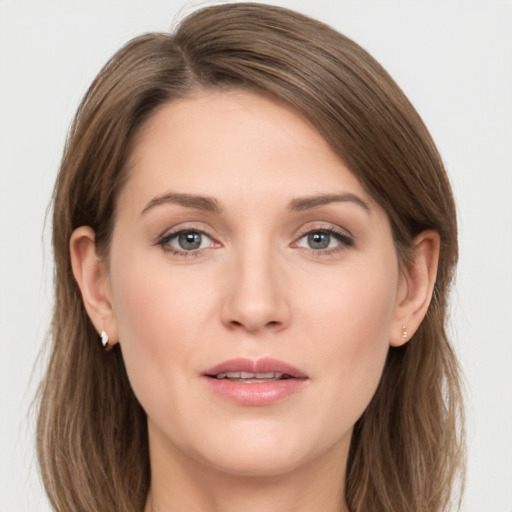 Joyful white young-adult female with long  brown hair and grey eyes