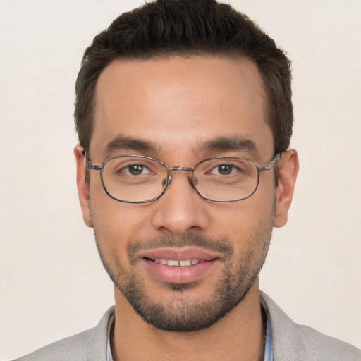 Joyful white young-adult male with short  black hair and brown eyes