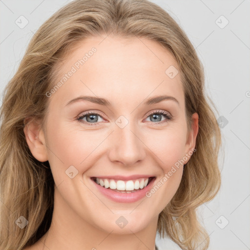 Joyful white young-adult female with long  brown hair and blue eyes