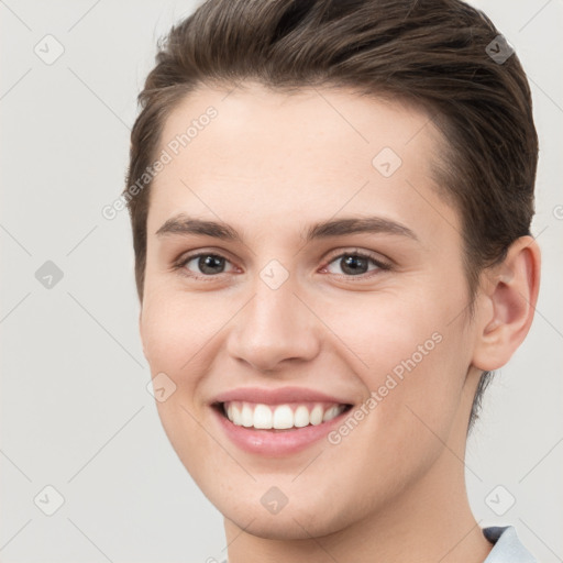 Joyful white young-adult female with short  brown hair and brown eyes