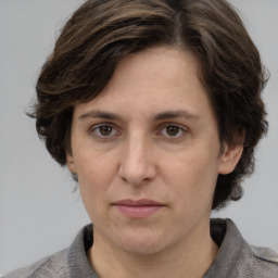 Joyful white adult female with medium  brown hair and grey eyes