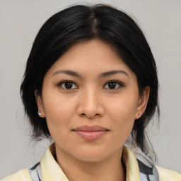 Joyful latino young-adult female with medium  brown hair and brown eyes