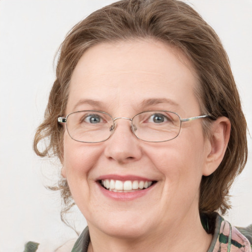 Joyful white adult female with medium  brown hair and blue eyes