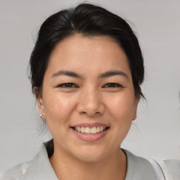 Joyful asian young-adult female with medium  brown hair and brown eyes