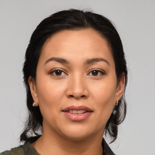 Joyful latino young-adult female with medium  brown hair and brown eyes