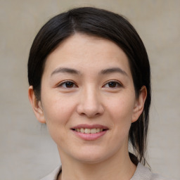 Joyful asian young-adult female with medium  brown hair and brown eyes