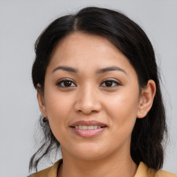 Joyful latino young-adult female with medium  brown hair and brown eyes