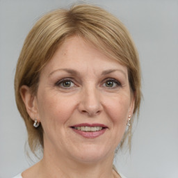 Joyful white adult female with medium  brown hair and grey eyes