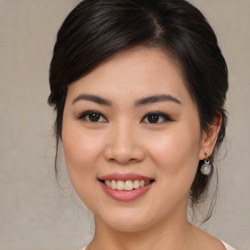 Joyful asian young-adult female with medium  brown hair and brown eyes