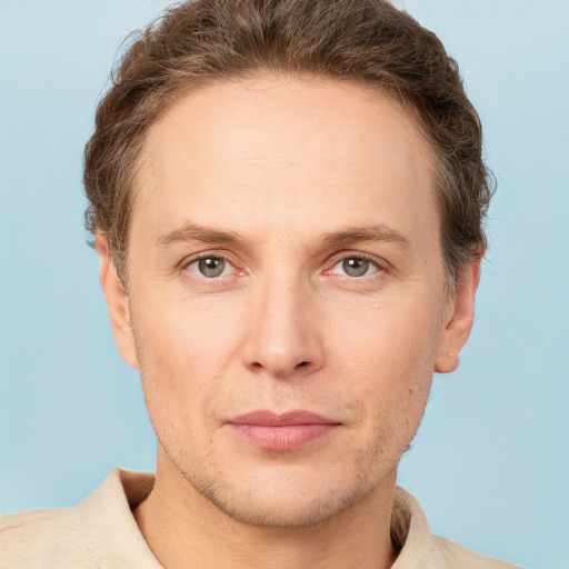 Joyful white adult male with short  brown hair and grey eyes