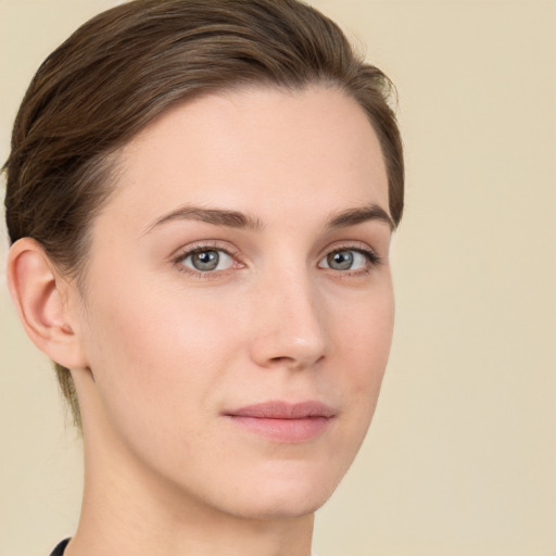 Joyful white young-adult female with short  brown hair and grey eyes