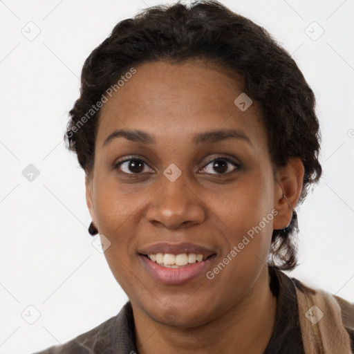 Joyful black young-adult female with short  brown hair and brown eyes