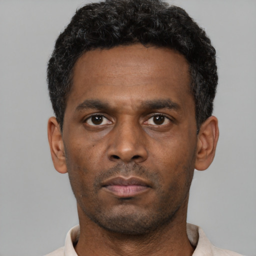 Neutral black young-adult male with short  black hair and brown eyes
