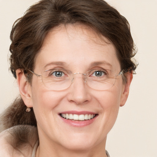 Joyful white adult female with medium  brown hair and grey eyes