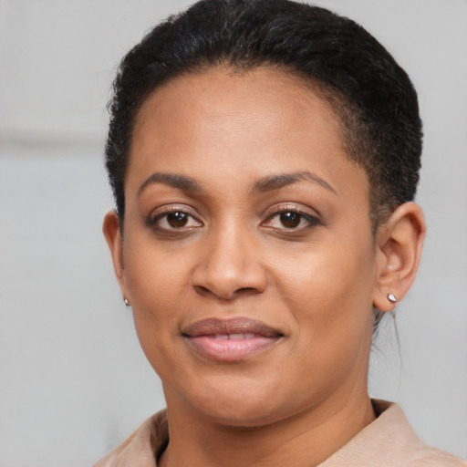 Joyful black young-adult female with short  brown hair and brown eyes