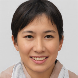 Joyful asian young-adult female with short  brown hair and brown eyes