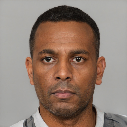 Neutral latino adult male with short  black hair and brown eyes