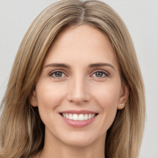 Joyful white young-adult female with long  brown hair and green eyes