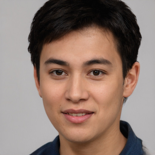 Joyful asian young-adult male with short  brown hair and brown eyes