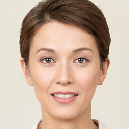 Joyful white young-adult female with short  brown hair and grey eyes