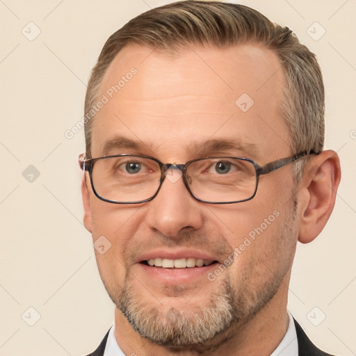 Joyful white adult male with short  brown hair and brown eyes