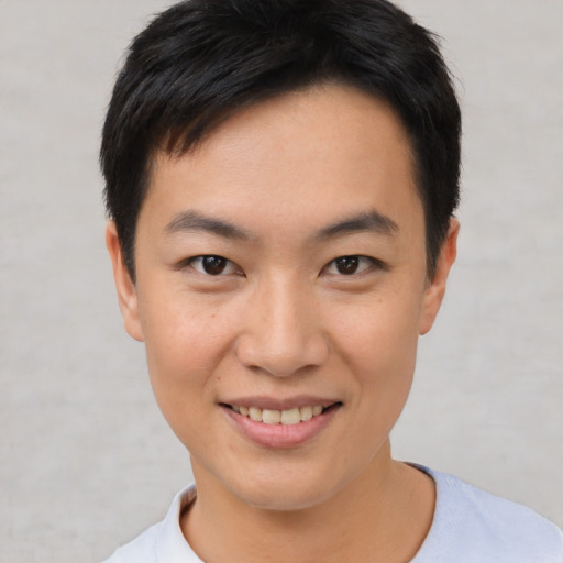 Joyful asian young-adult male with short  black hair and brown eyes