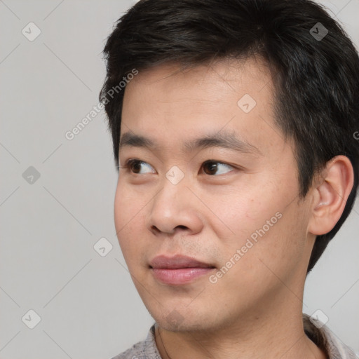 Joyful white young-adult male with short  black hair and brown eyes