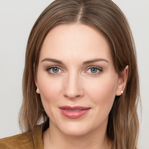 Joyful white young-adult female with medium  brown hair and grey eyes