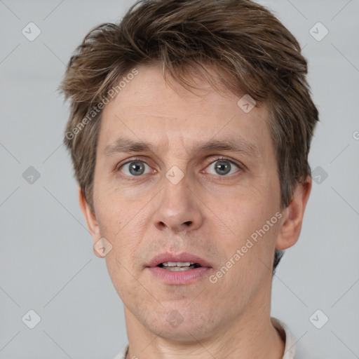 Joyful white adult male with short  brown hair and grey eyes